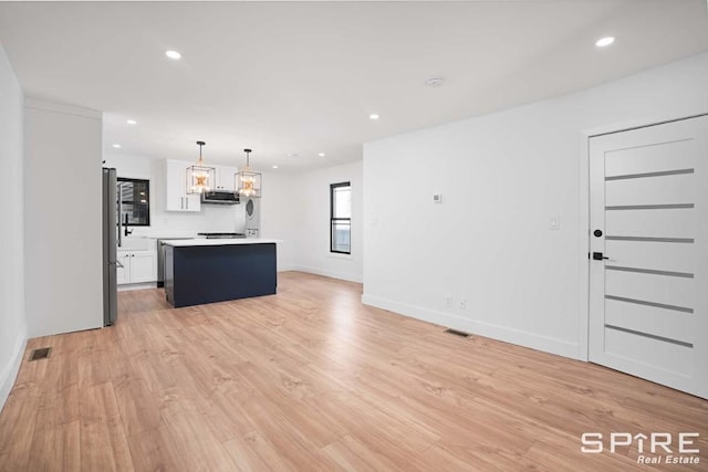 kitchen featuring light wood-style flooring, visible vents, appliances with stainless steel finishes, and a kitchen island