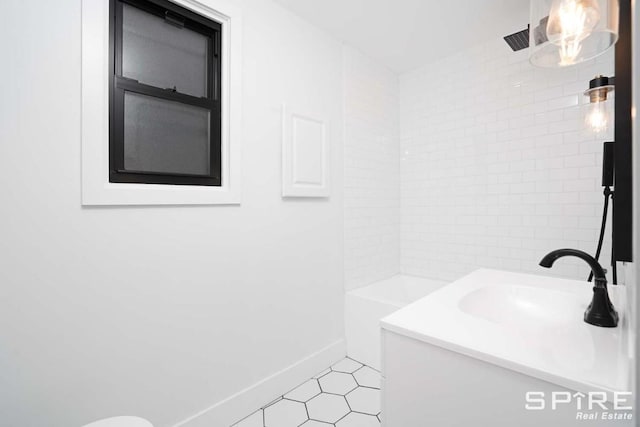 bathroom with tile patterned floors, baseboards, walk in shower, and vanity