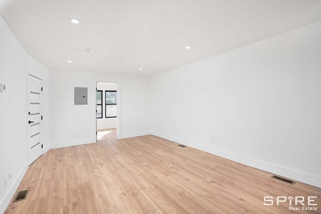 empty room featuring recessed lighting, visible vents, baseboards, and light wood-style floors