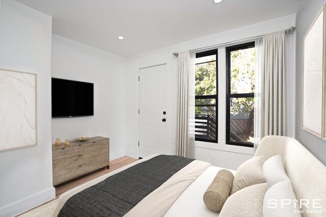 bedroom with recessed lighting, baseboards, and wood finished floors