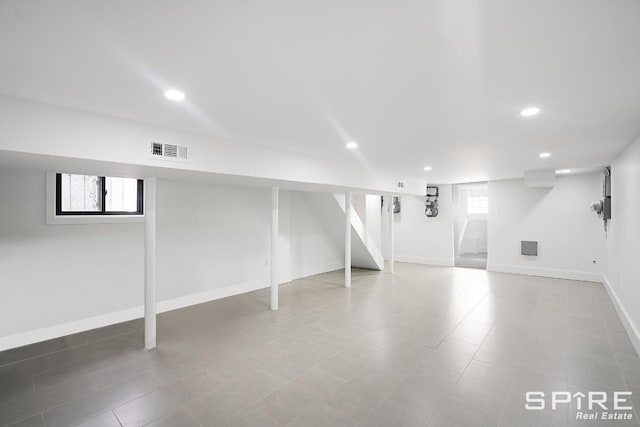 basement featuring plenty of natural light, recessed lighting, and visible vents