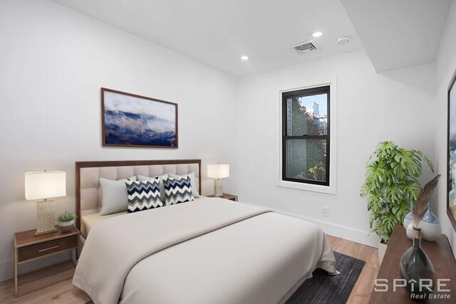 bedroom featuring recessed lighting, wood finished floors, visible vents, and baseboards