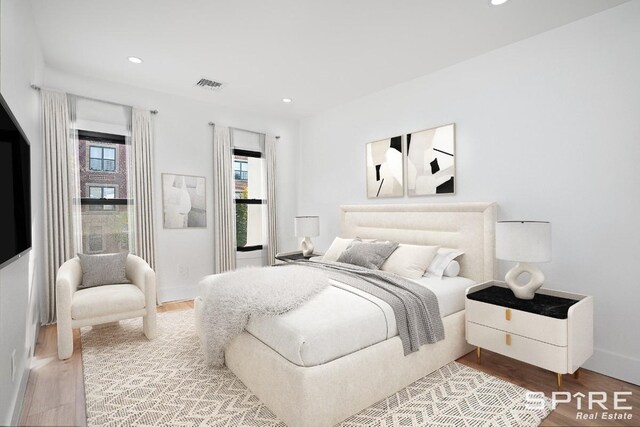 bedroom featuring recessed lighting, visible vents, baseboards, and wood finished floors