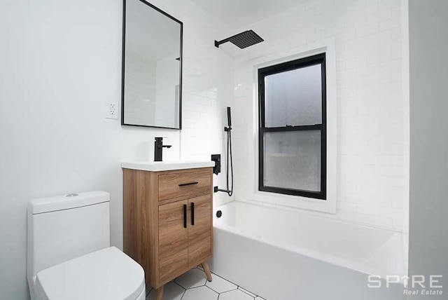 bathroom featuring tile patterned flooring, bathing tub / shower combination, vanity, and toilet