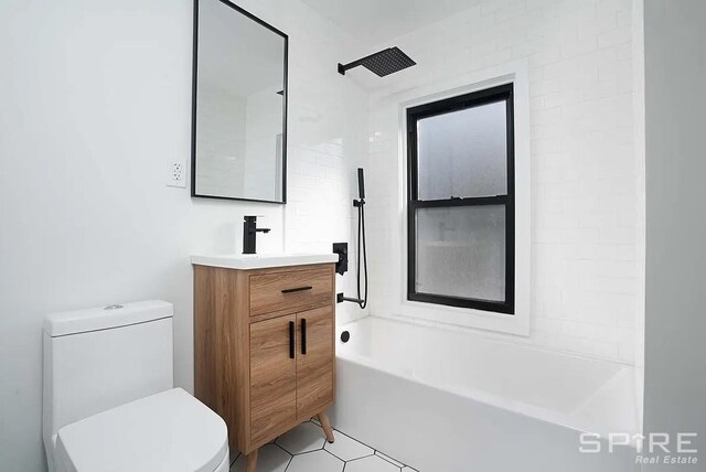 bathroom with tile patterned floors, bathing tub / shower combination, vanity, and toilet