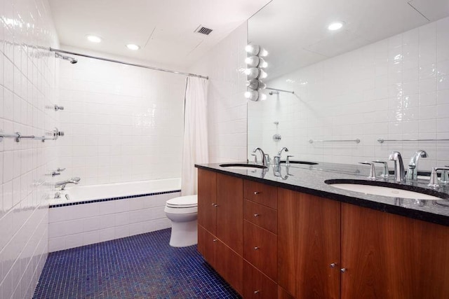 full bathroom with toilet, shower / tub combo, tile walls, tile patterned floors, and vanity