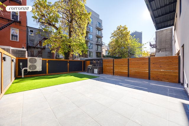 view of patio / terrace featuring ac unit, fence, and a gate