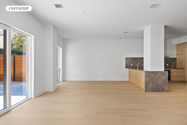 interior space featuring light wood-type flooring, visible vents, and recessed lighting