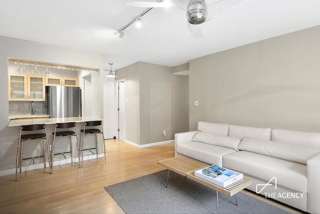 living room featuring light wood-style flooring and baseboards