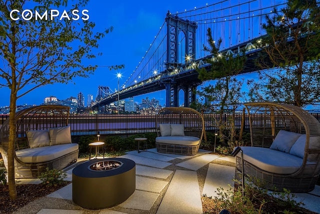 view of patio featuring a view of city and fence