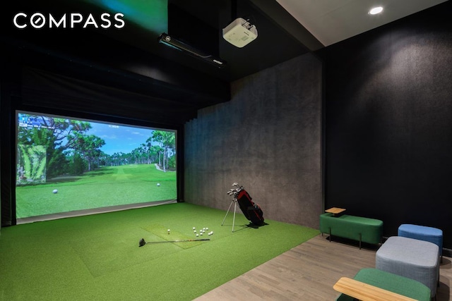 recreation room featuring golf simulator and wood finished floors