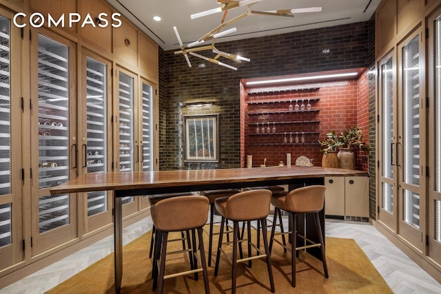 wine cellar featuring brick wall and indoor wet bar