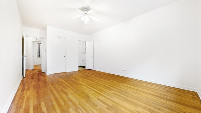 unfurnished bedroom with a ceiling fan, baseboards, and light wood finished floors