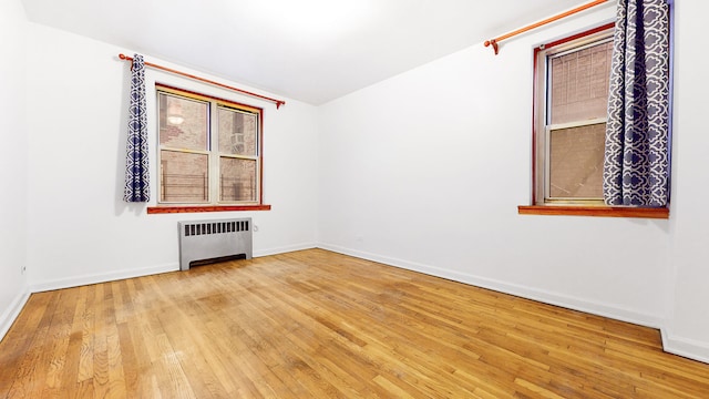 25 Indian Rd Unit 2G, New York City, NY 10034 - unfurnished room featuring radiator heating unit, baseboards, and hardwood / wood-style floors