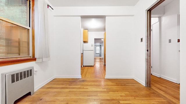 25 Indian Rd Unit 2G, New York City, NY 10034 - hall with light wood-type flooring, baseboards, and radiator