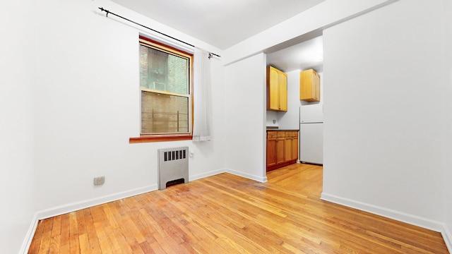 25 Indian Rd Unit 2G, New York City, NY 10034 - spare room featuring radiator, baseboards, and light wood-type flooring