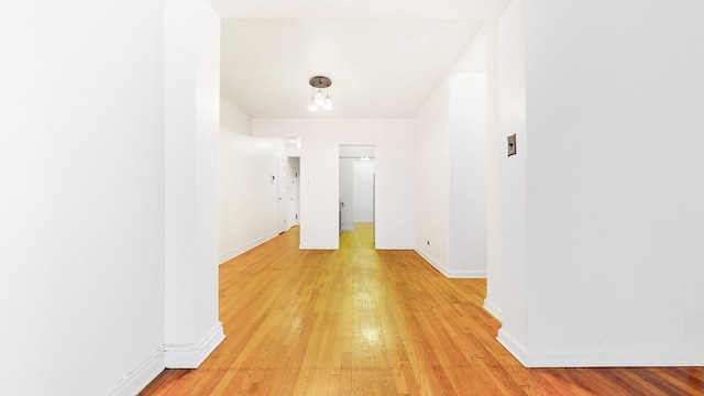 spare room with light wood finished floors and baseboards