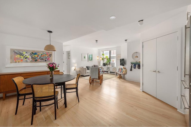 dining space featuring light wood-type flooring