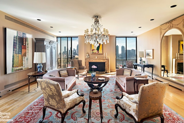 living room with a notable chandelier, floor to ceiling windows, and light wood-type flooring