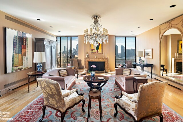 living room with light hardwood / wood-style flooring, floor to ceiling windows, and a chandelier