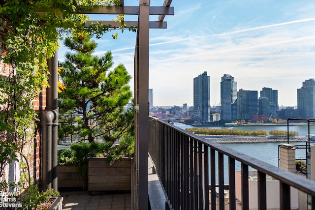 balcony featuring a city view and a water view