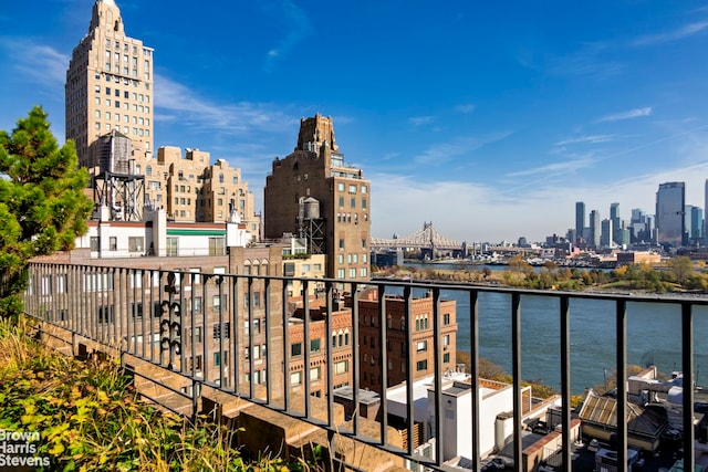 balcony featuring a view of city and a water view