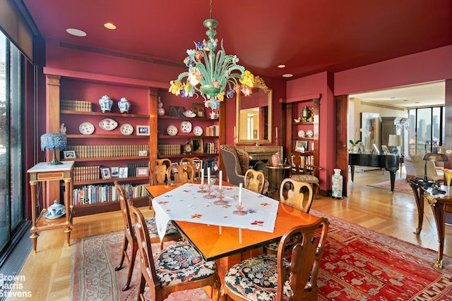 dining area with recessed lighting, wood finished floors, and a chandelier