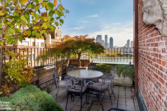 balcony with a view of city and outdoor dining space