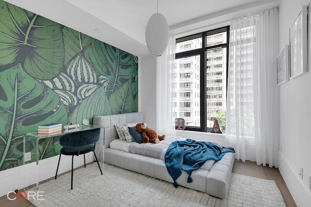 bedroom featuring multiple windows and hardwood / wood-style flooring