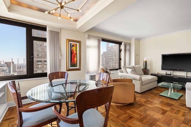 dining space featuring a notable chandelier, a city view, crown molding, and a tray ceiling