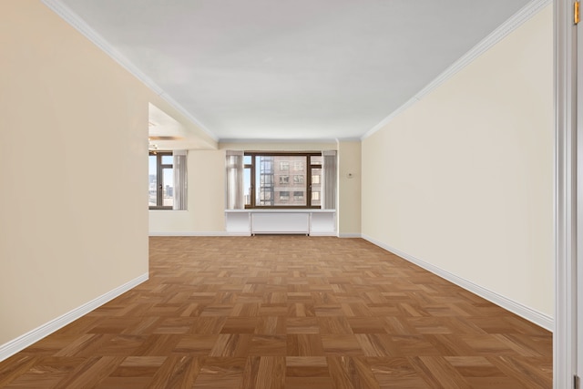 empty room featuring baseboards and ornamental molding