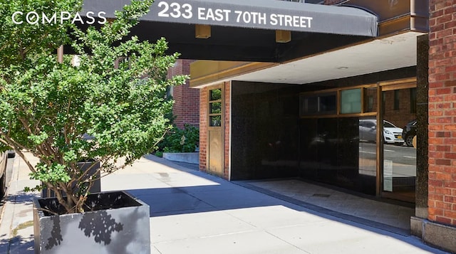 property entrance featuring brick siding