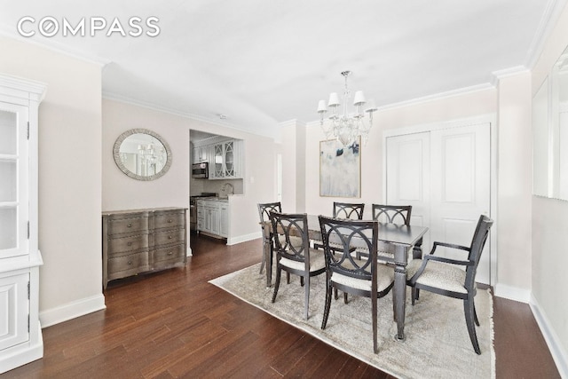 dining space featuring crown molding, dark wood-type flooring, and a notable chandelier