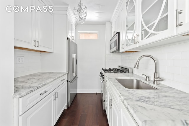 kitchen with dark wood-type flooring, white cabinetry, a sink, and high quality appliances