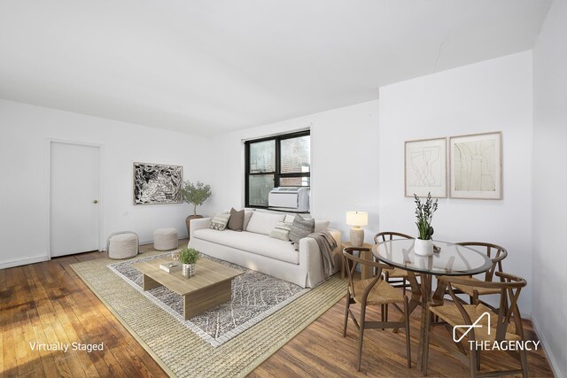 living room featuring cooling unit and dark wood-type flooring