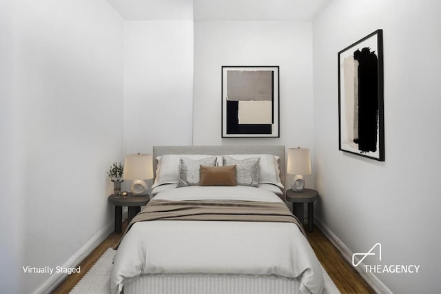 bedroom featuring dark wood finished floors and baseboards