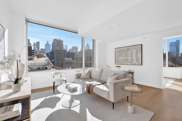 611 W 56th St Unit 7A, New York City, NY 10019 - living room featuring wood finished floors and a view of skyline