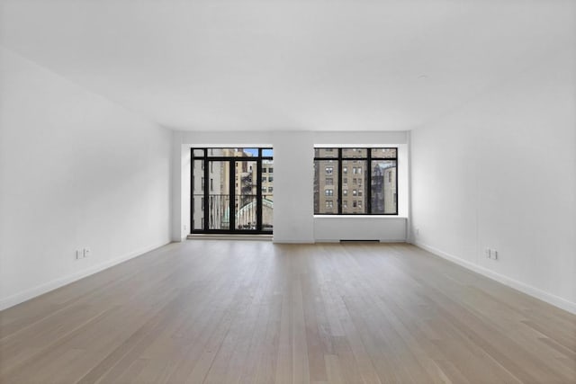 spare room featuring light wood-type flooring