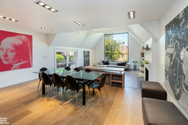 800 W 231st St, New York City, NY 10463 - dining room featuring healthy amount of natural light, light wood-style flooring, vaulted ceiling, and baseboards