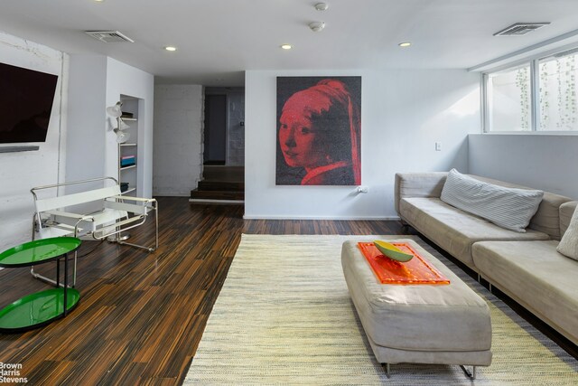 living room featuring dark wood-type flooring, recessed lighting, and visible vents