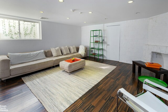 living room with dark wood-style flooring, visible vents, and recessed lighting