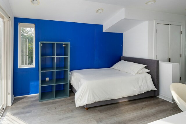 bedroom with light wood-style flooring and recessed lighting