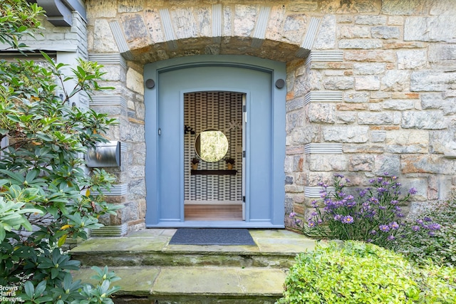 property entrance with stone siding