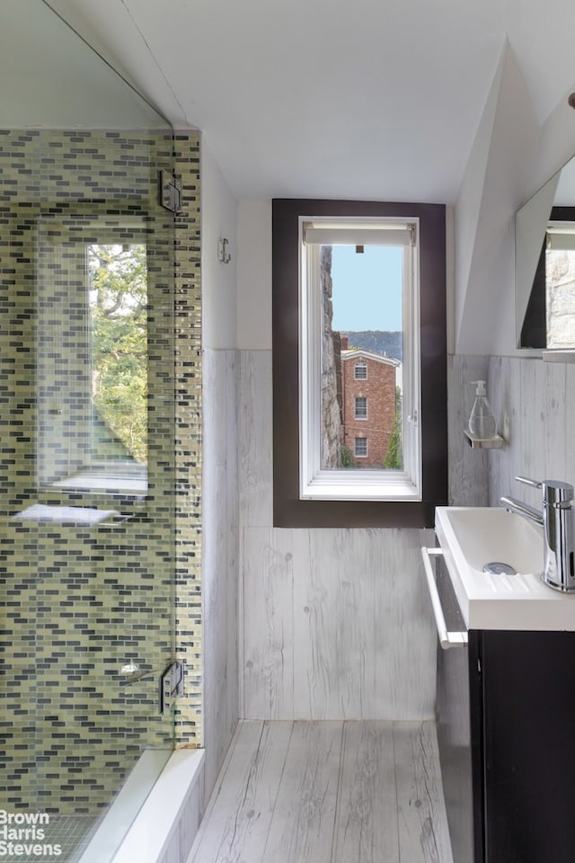 800 W 231st St, New York City, NY 10463 - full bathroom with vanity, a shower stall, tile walls, and a wainscoted wall
