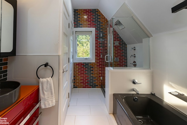 800 W 231st St, New York City, NY 10463 - bathroom with tile walls, tiled shower, tile patterned flooring, a bath, and vanity