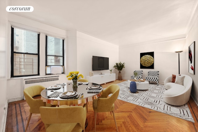 living room featuring radiator heating unit, ornamental molding, and parquet floors