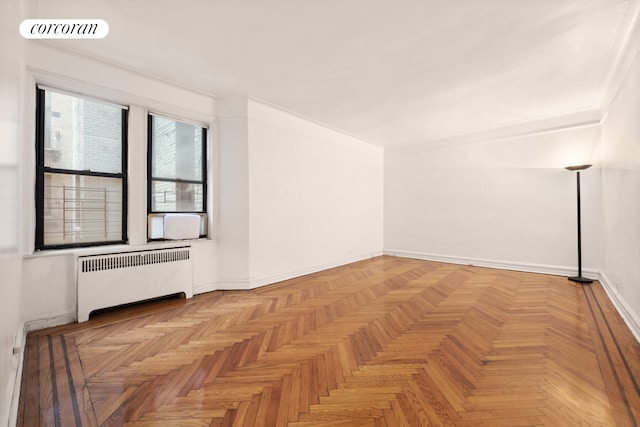 bonus room with radiator heating unit and baseboards