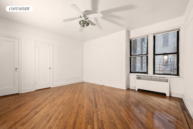 unfurnished bedroom featuring radiator heating unit, wood finished floors, and ceiling fan