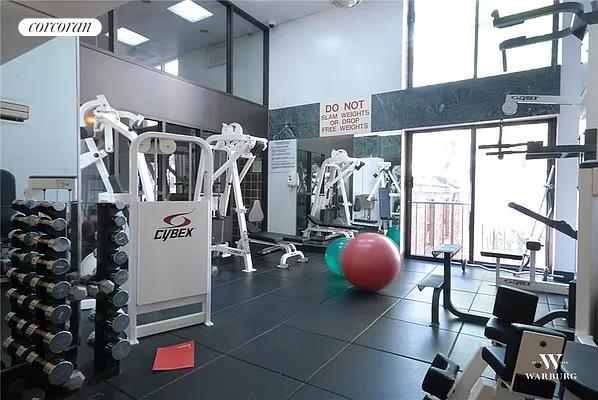 workout area featuring a high ceiling