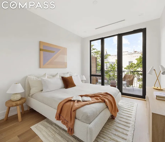 bedroom featuring access to outside and light wood-type flooring